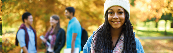 A student standing in the foreground of her colleagues.