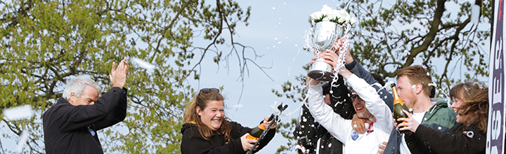 Students lift the Carter James Trophy in victory as champagne is opened in celebration.