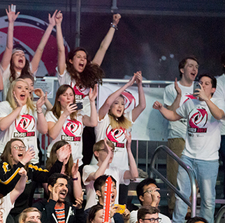 Students cheering in the Roses audience.