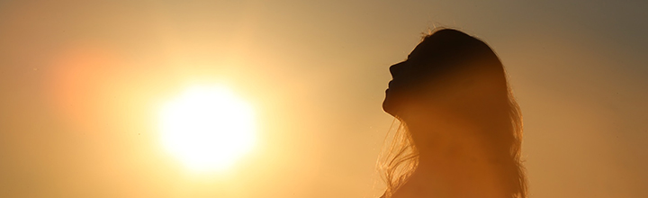 Silhouette of a woman against the sunset.