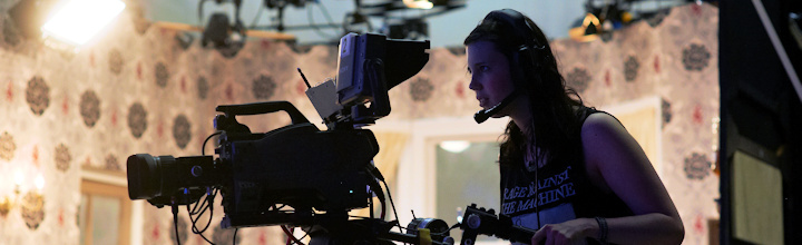 Camera operator filming on a TV set