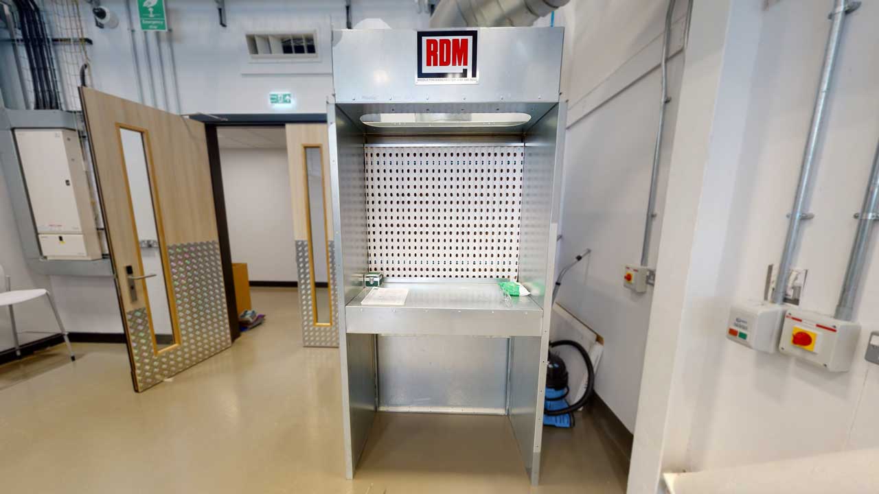 The lab's spray booth with large hood to extract fumes