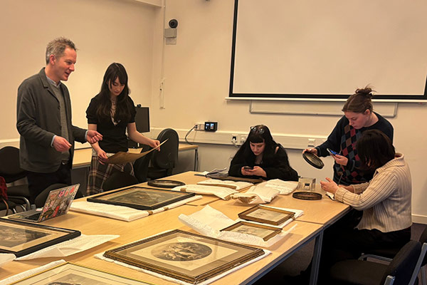 A group of students handling some of the University of York's art collection.