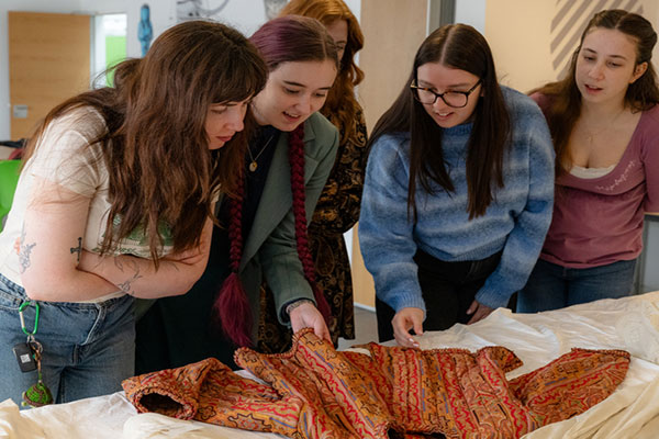 Exploring Victorian garments during a curator-led workshop at the Leeds Discovery Centre.