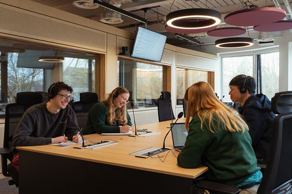 A group of students using the multilingual conference suite.