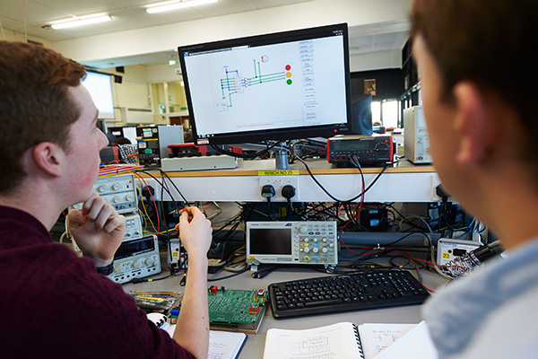 Two students in the Department of Electronic Engineering working in the lab.