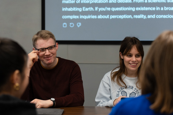 Two students discussing philosophy in a seminar
