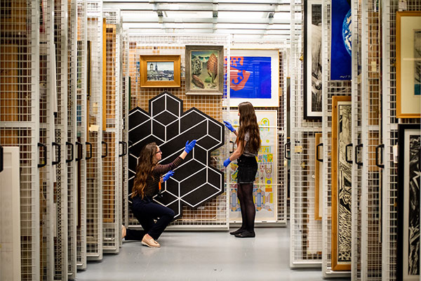 Students looking at black and white geometric art