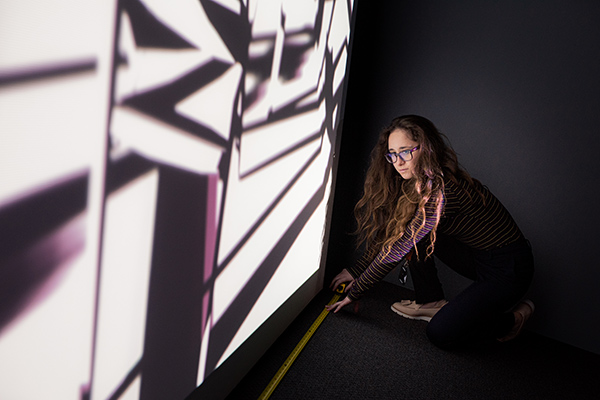 Student measuring black and white image projection
