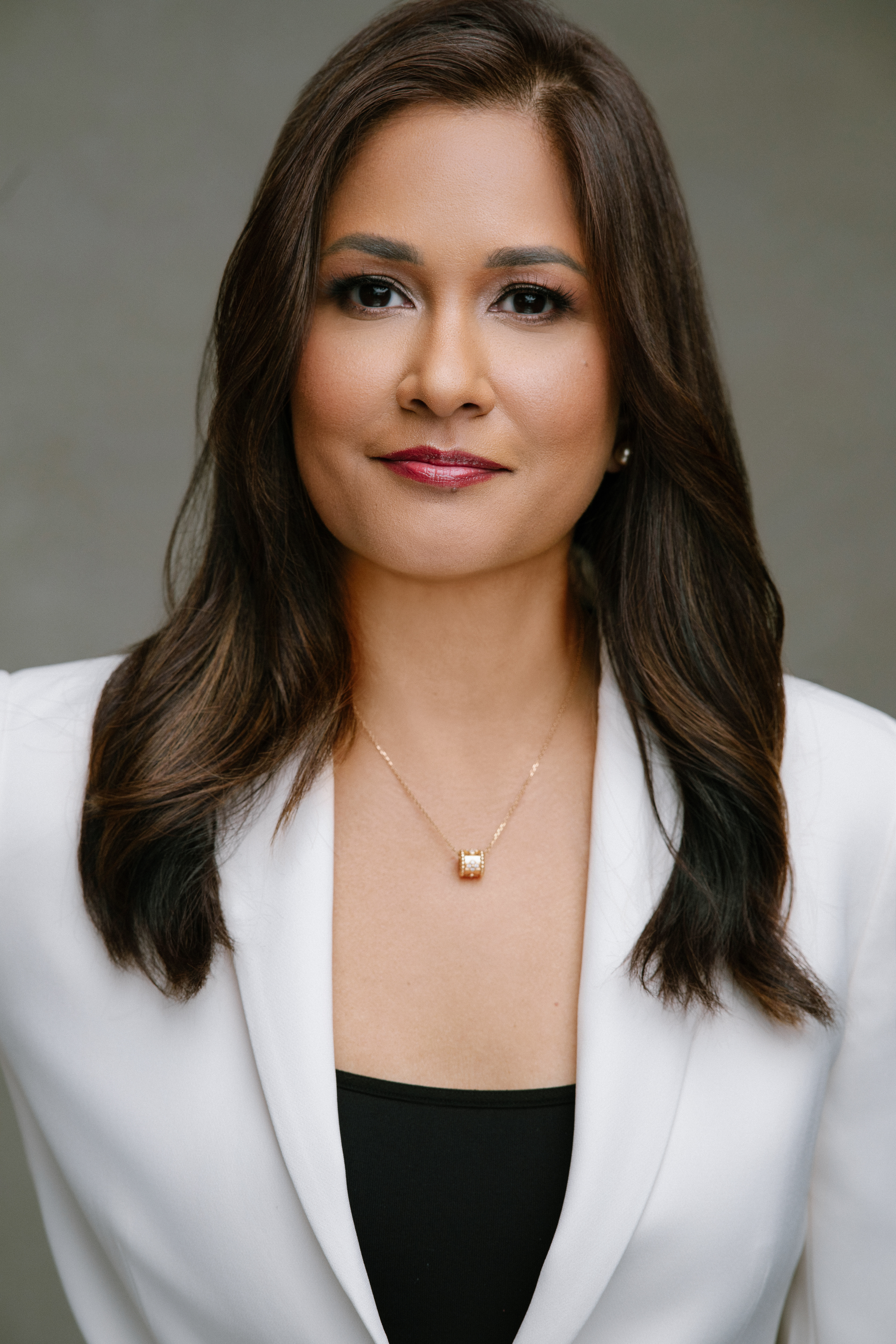 Dr. Nesha Beharry-Borg headshot, wearing a white jacket against a grey background