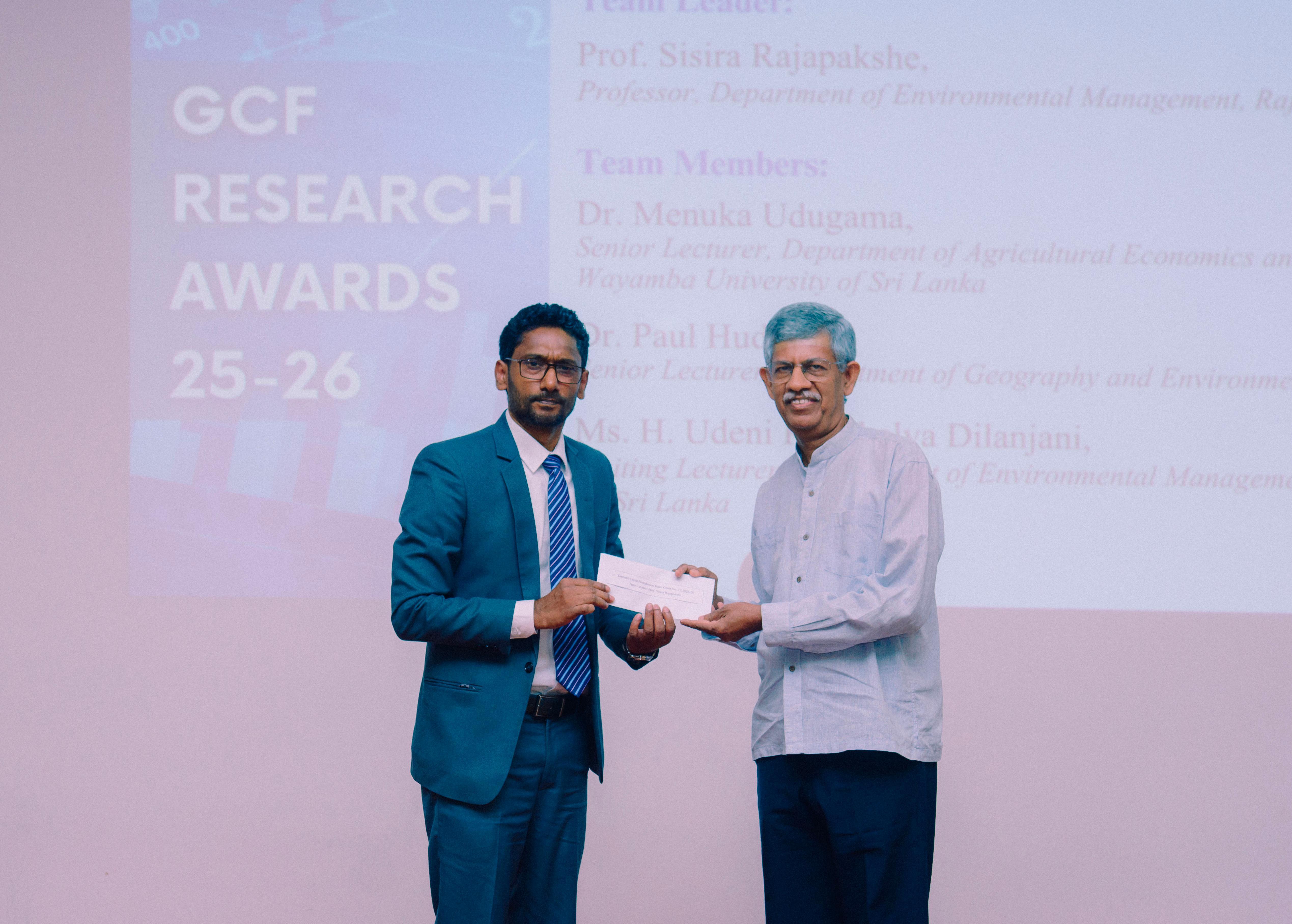Professor Sisira Rajapakshe receiving the Gamani Corea Foundation research grant award during a formal ceremony