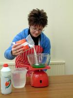 Picture of step 2, adding salt to washing-up liquid in a bowl.